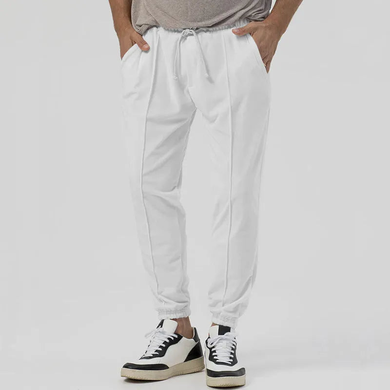Men's grey track sweatpants with elastic waistband and straight-leg tapered fit