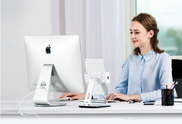 Silver aluminium and ABS folding stand holding a tablet, showing 360-degree rotation and anti-slip silicone pads.