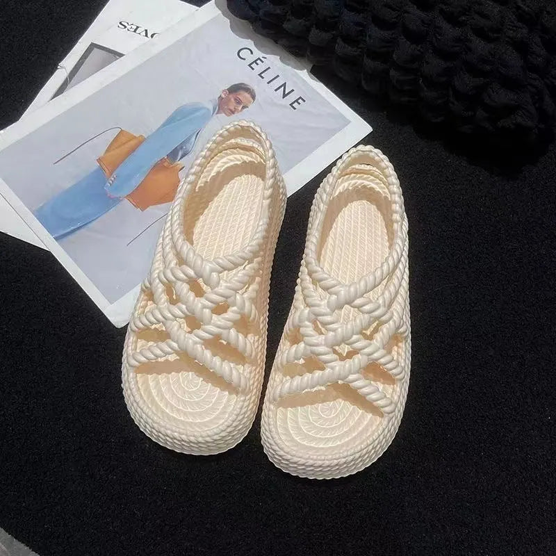 Beige PVC sandals with sunflower pattern and round toe on a non-slip sole.