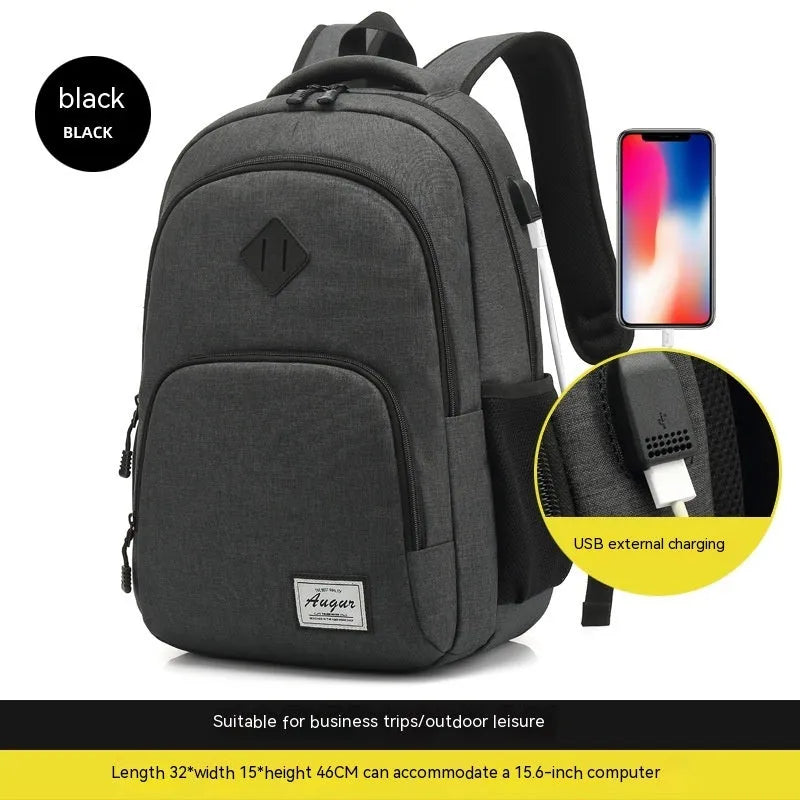 Gray nylon backpack with USB charging port and trolley sleeve on a suitcase.