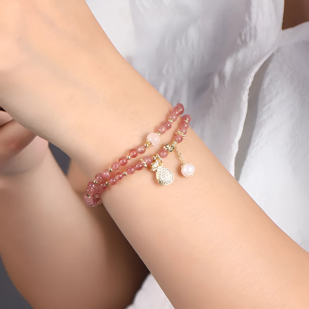 Women's strawberry quartz bracelet with geometric wallet-style design and adjustable beaded construction
