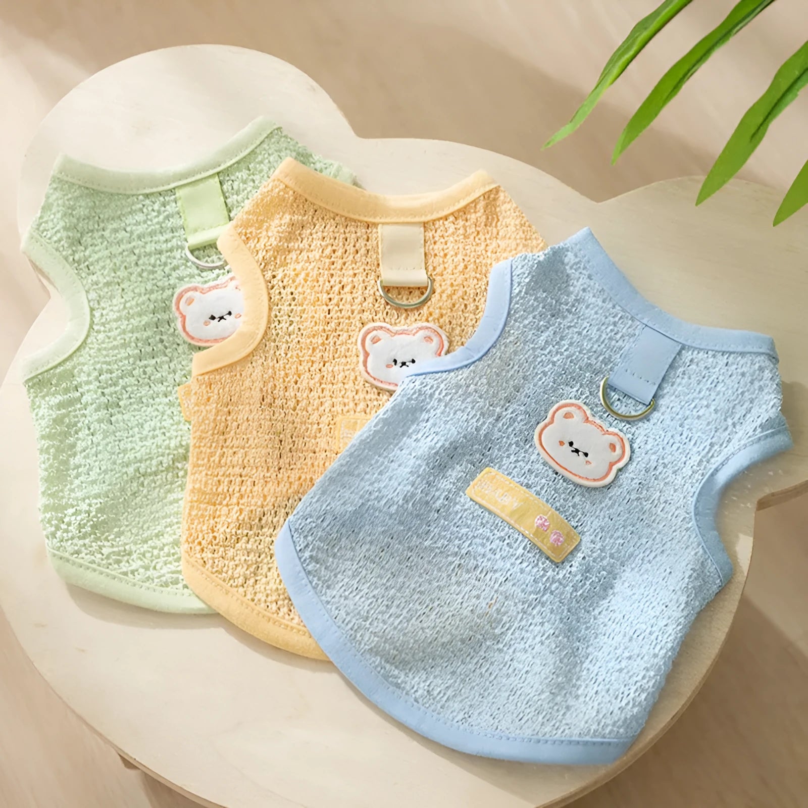 Green bear patch cat clothing with hollowed-out knitted fabric design on a feline