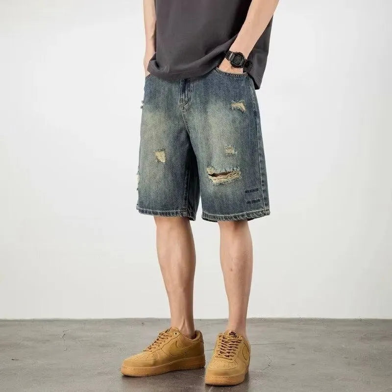 Retro blue denim men's shorts with loose hole details and straight leg.