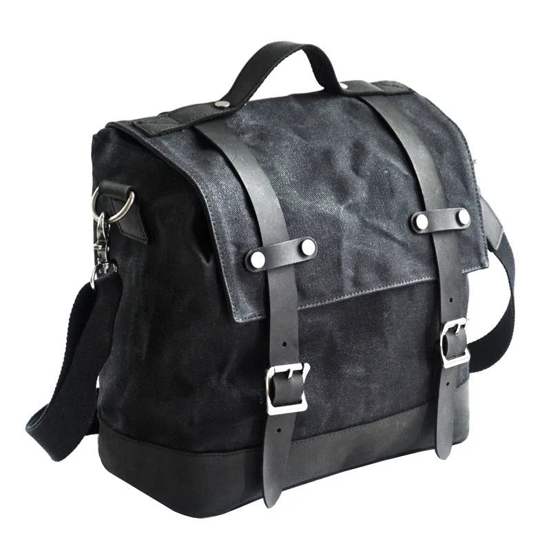 Waterproof canvas motorcycle side pannier bag in black mounted to motorcycle
