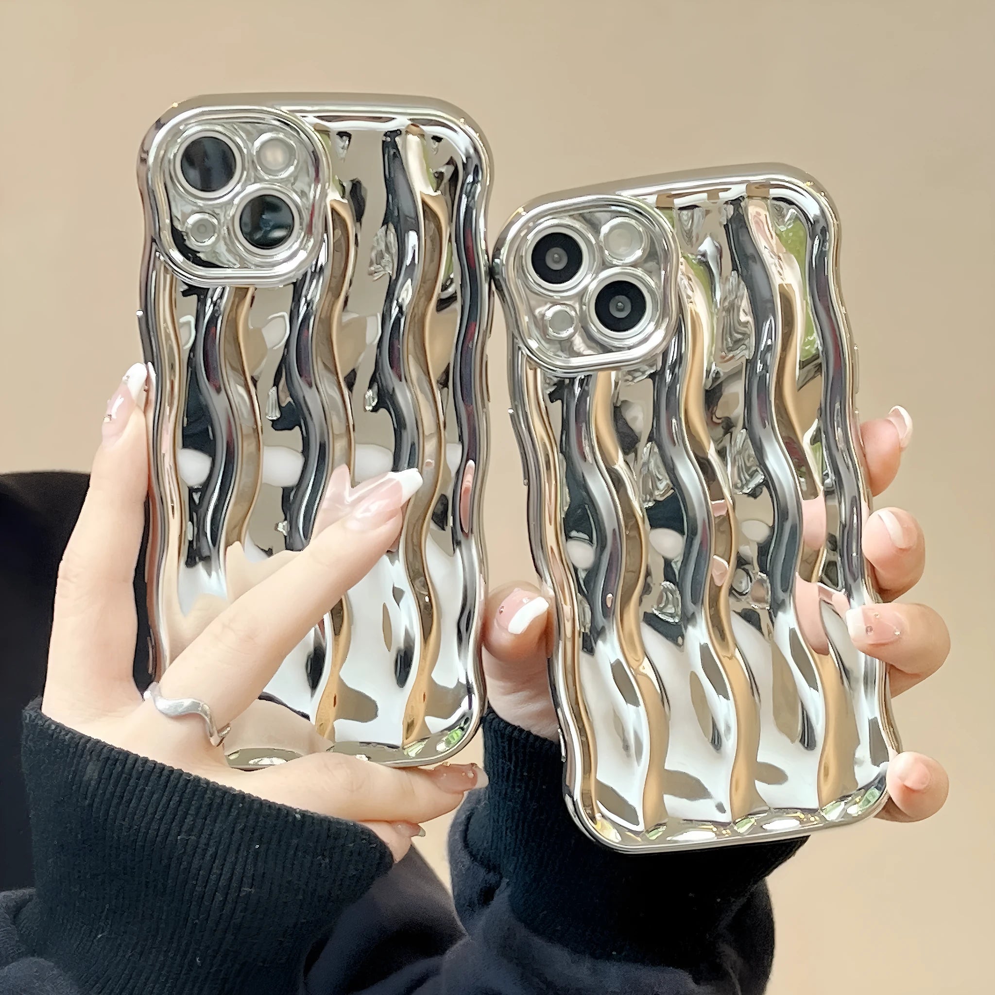 iPhone 17 Pro Max in a silver electroplated TPU case with a textured wave stripe pattern on the back.