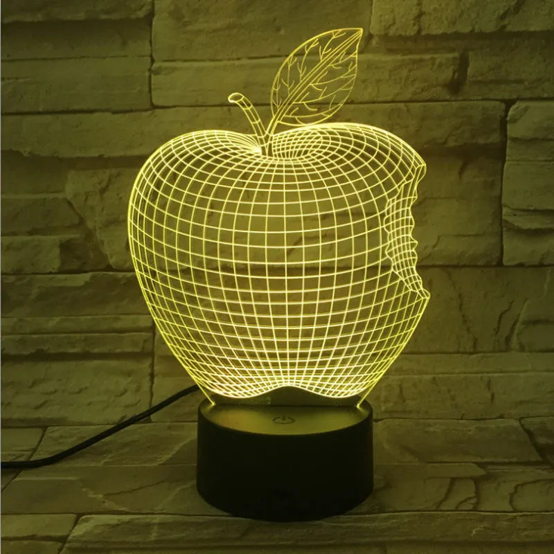 3D fruit-shaped colourful night light with touch controls and acrylic shade on a surface.