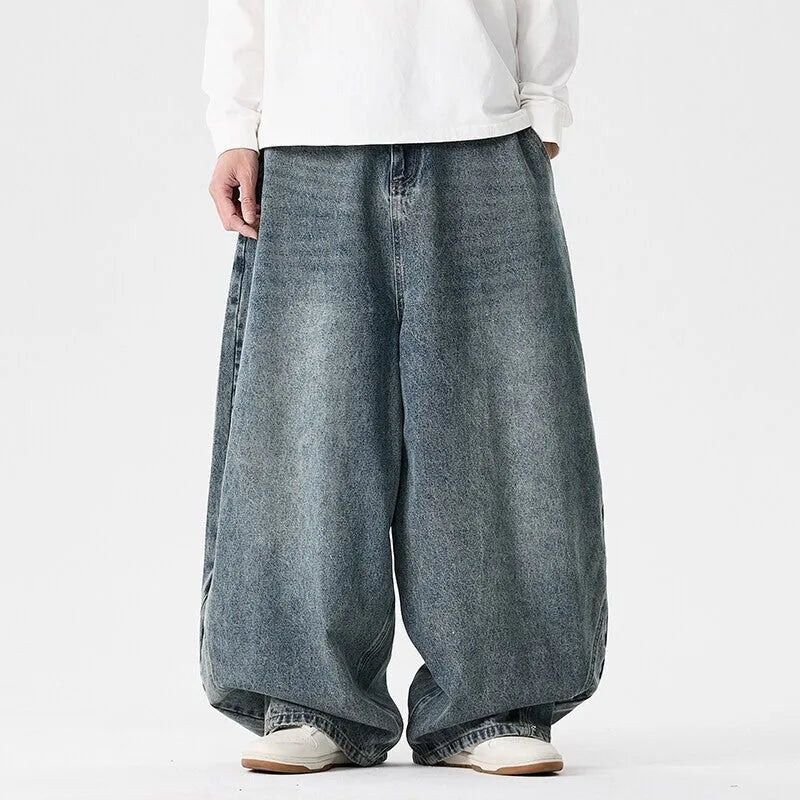 Men's plus size baggy wide leg jeans in light blue denim laid flat