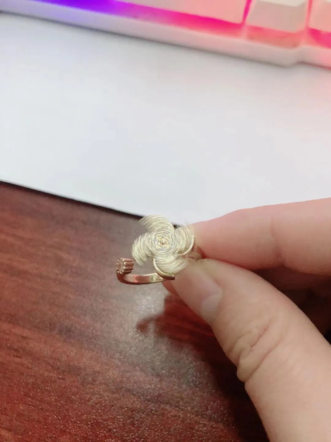 Copper spinning windmill ring with geometric shape, shown in gold and silver colour options.