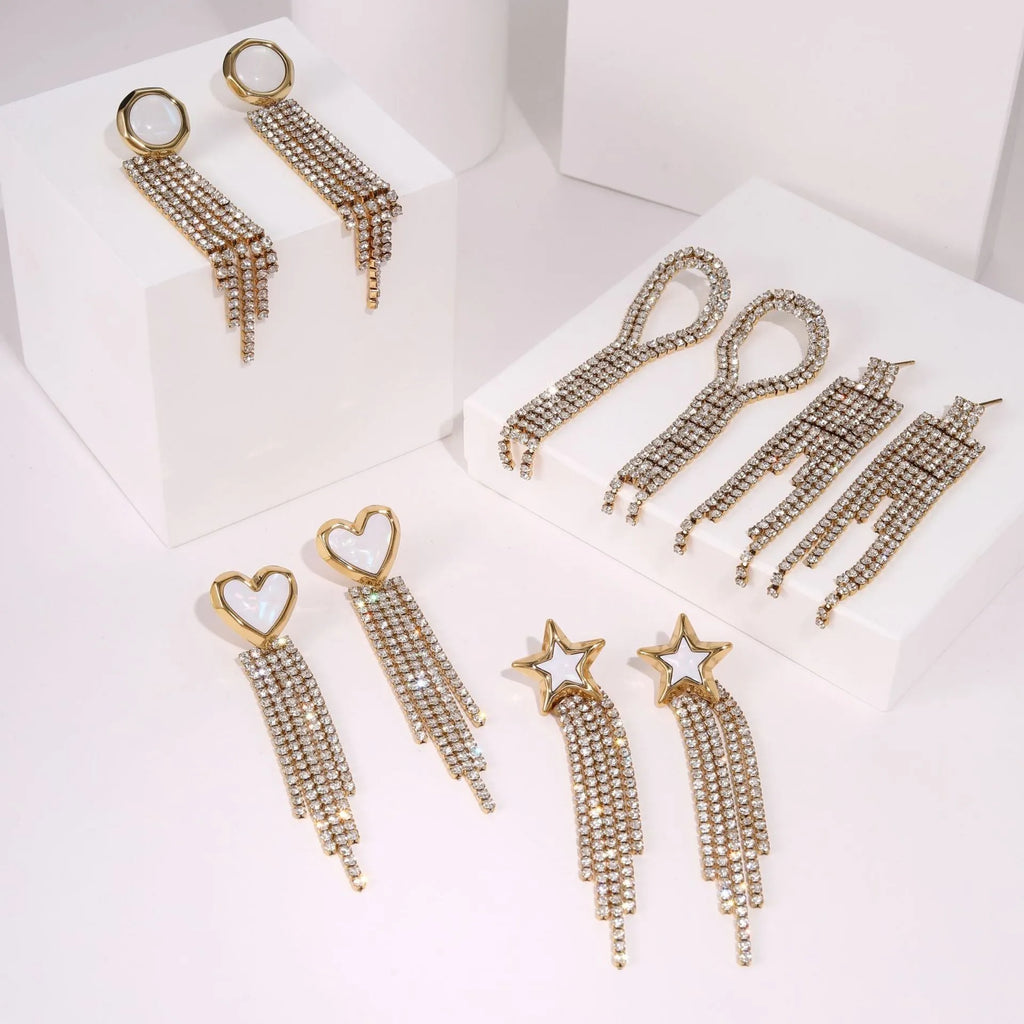 Stainless steel tassel earrings with 18K gold electroplated finish and diamond tips in heart and star shapes