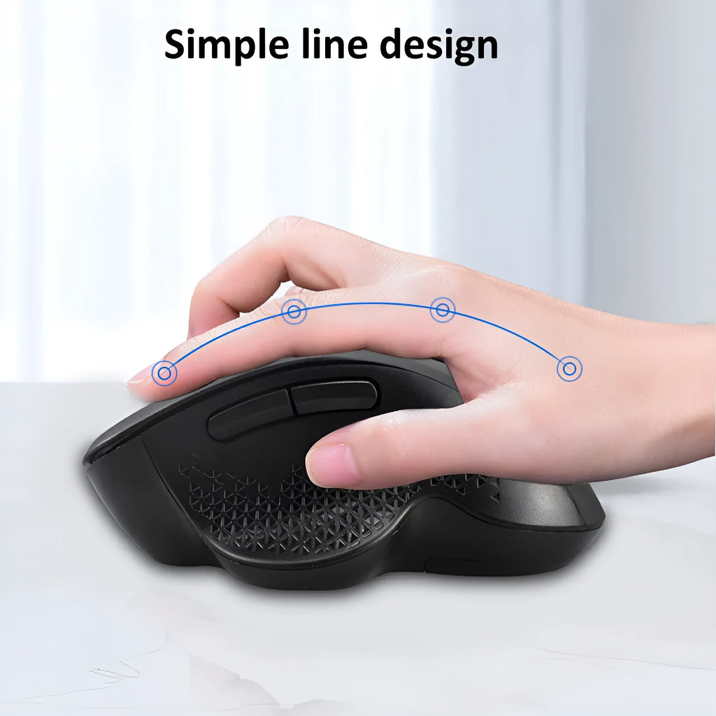 Black wireless laptop mouse with USB-C charging cable on desk next to laptop