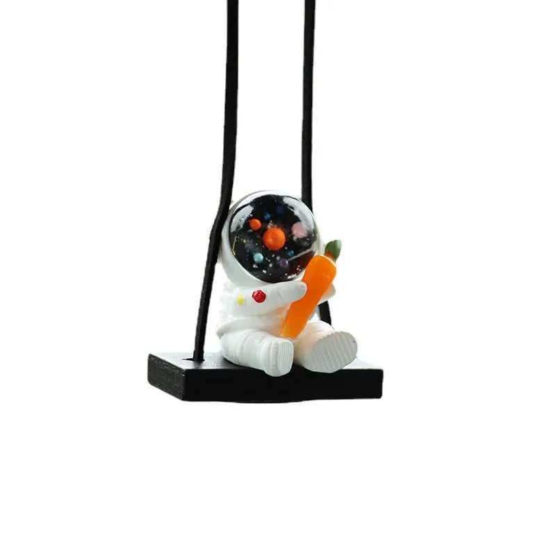 Resin cartoon astronaut car pendant available in red flag, telescope, and radish holding styles for dashboard decoration.