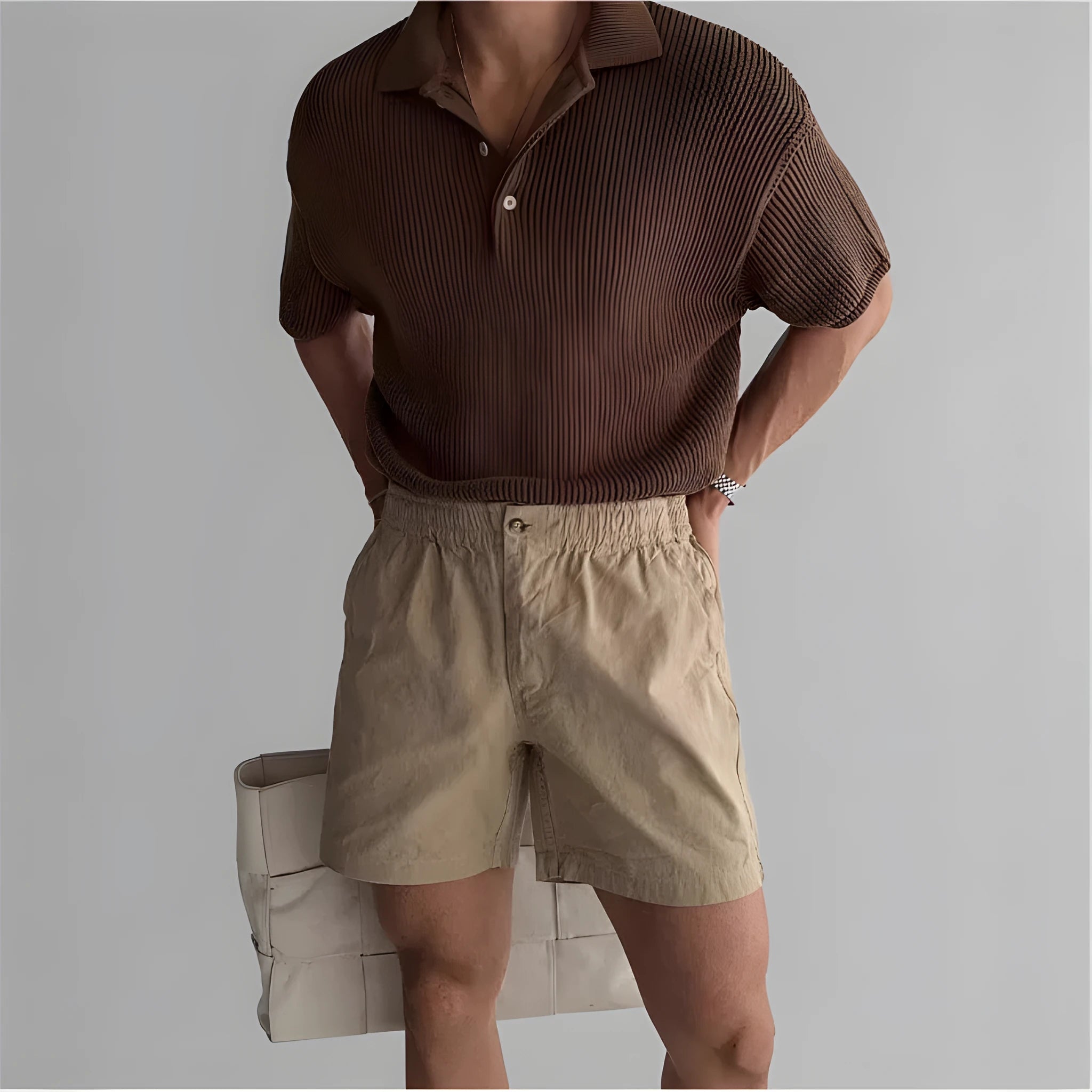 Men's loose-fit cotton sports shorts in khaki colour on a white background.