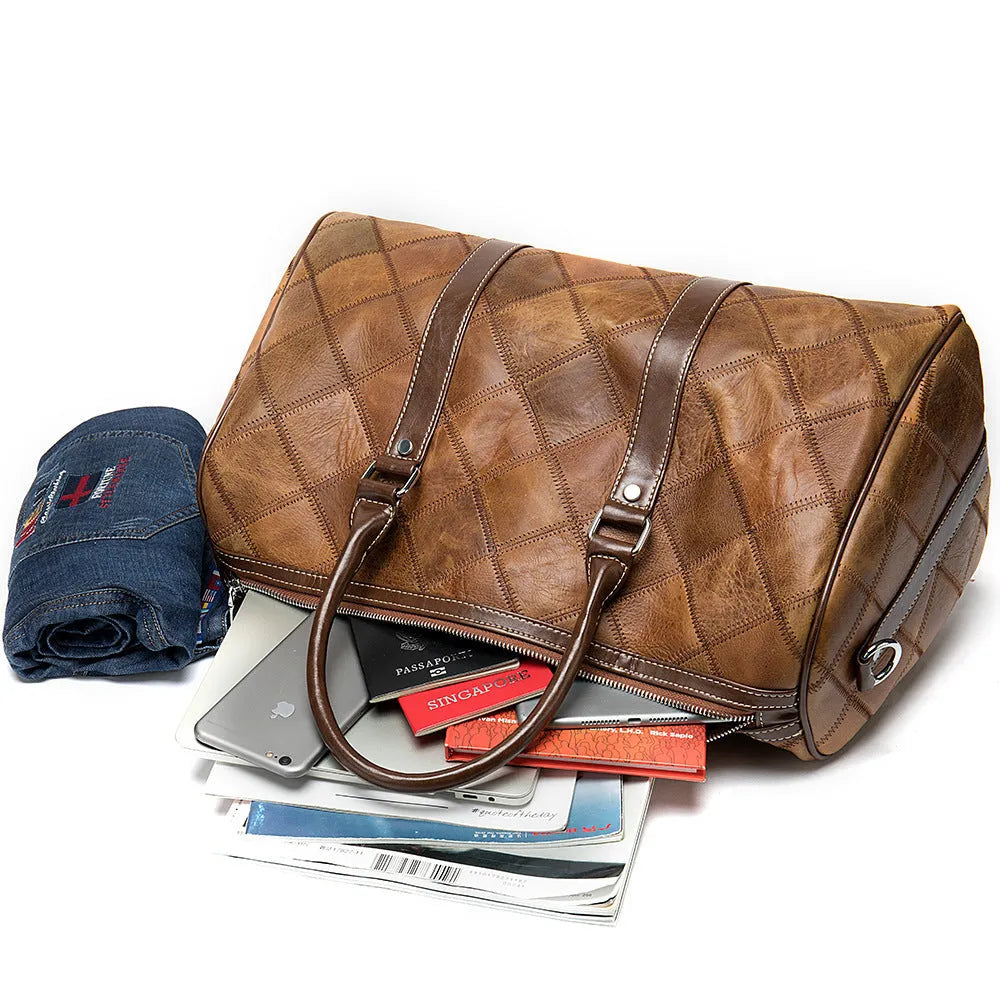 Vintage brown cowhide leather duffel bag with single shoulder strap showing internal organisation compartments