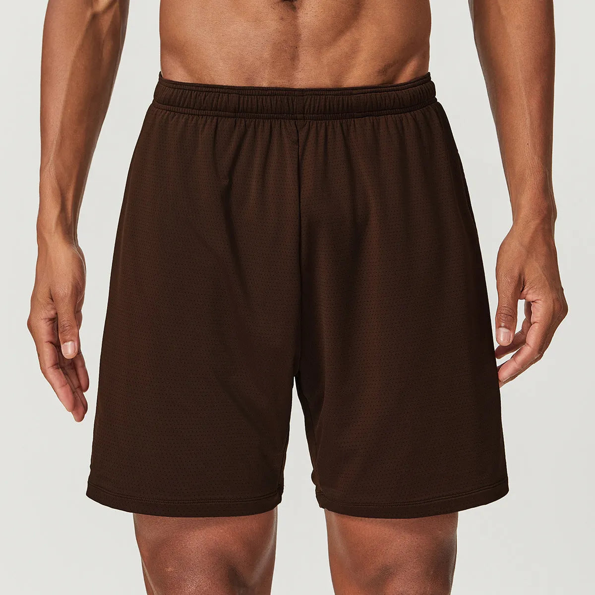 Men's double-layer quick-drying running shorts in brick red colour on a mid-waist model.