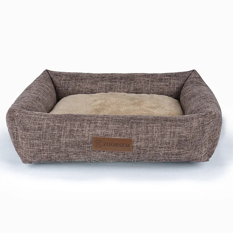 Grey plaid square cloth dog bed for medium-sized dogs on a wooden floor.