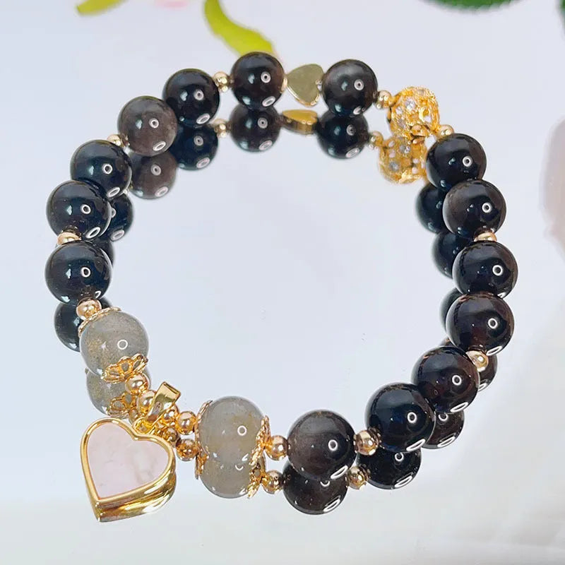 Adjustable silver stone bracelet for women with choice of flower, love, or star charm on a white background.