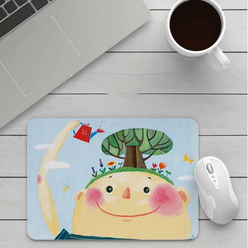 Custom cartoon design on a small black thickened mouse pad with stitching, shown on a desk.