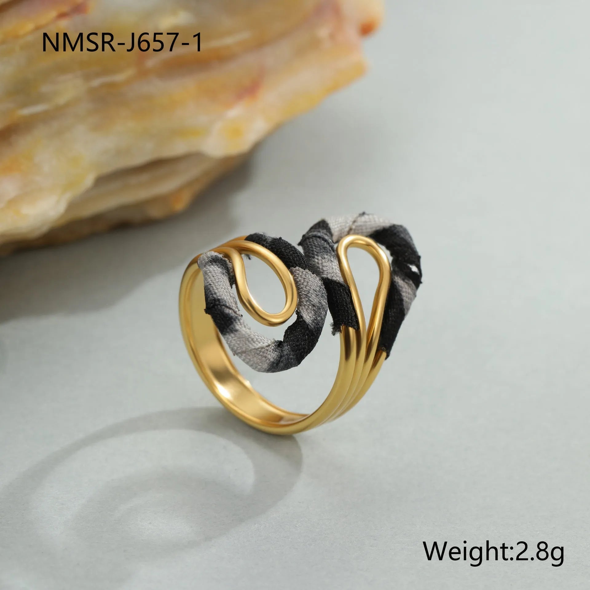 Stainless steel open mouth ring with leopard print in geometric shape on a hand.