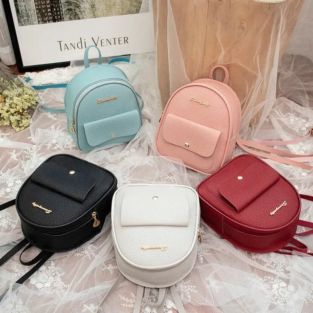 Women's small black PU leather backpack shoulder bag showing front zipper and dimensions