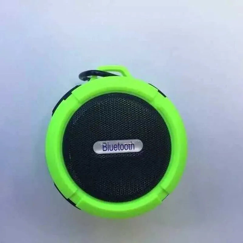 Portable waterproof Bluetooth speaker in multiple colours with a mountaineering buckle for bag attachment.