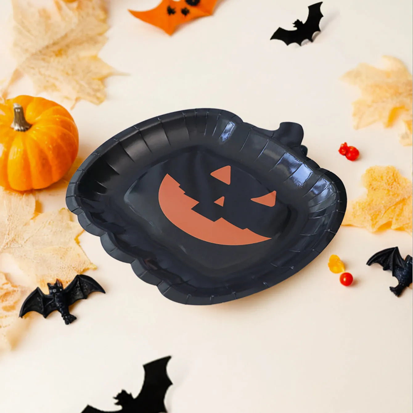 Black Halloween pumpkin design disposable paper plates in 9-inch size for parties