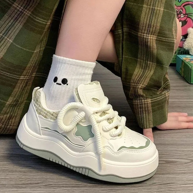 Women's green and pink patent leather platform sneakers with round toe and lace-up closure