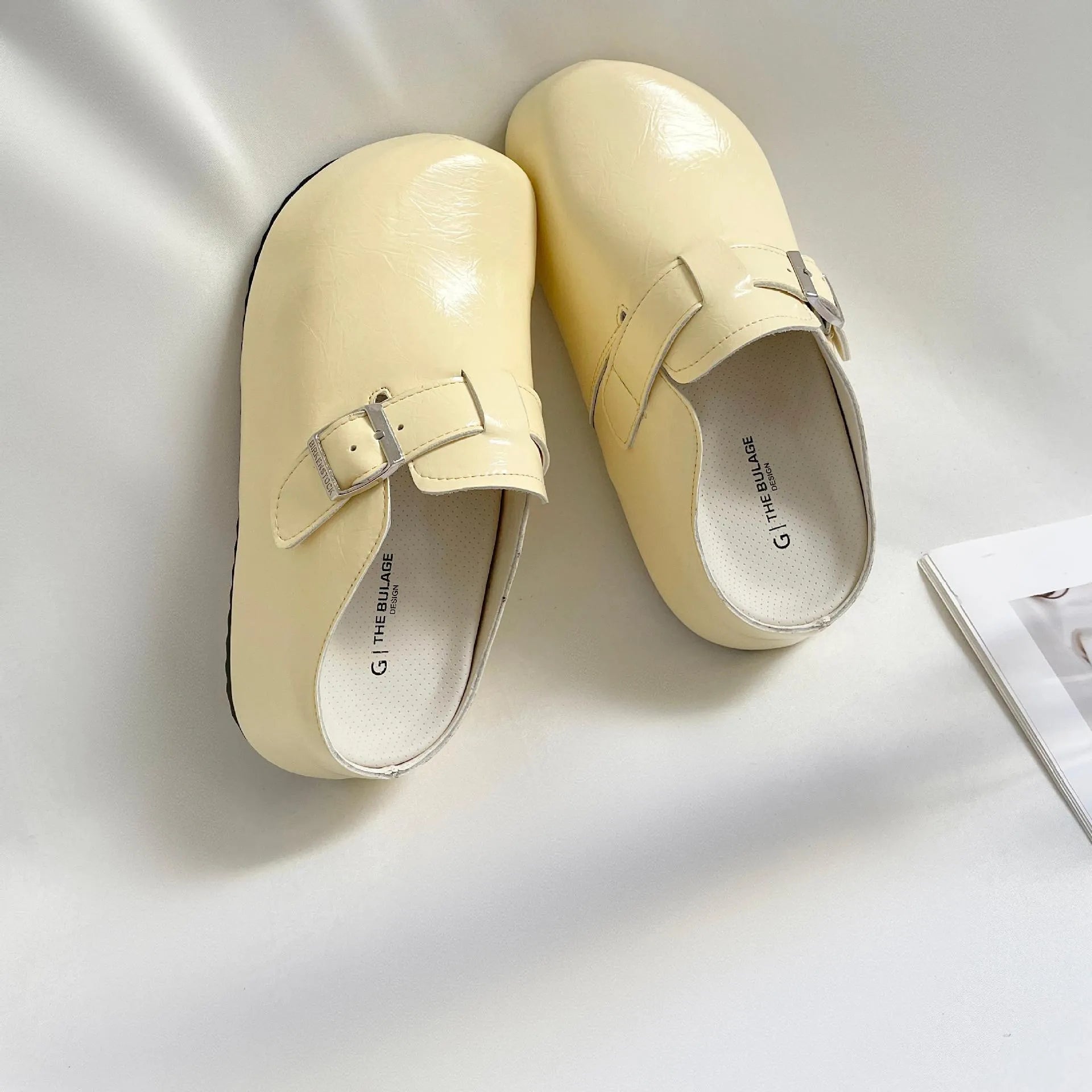 Flat buckle casual sneakers in yellow, round toe, PU upper, on a white background.