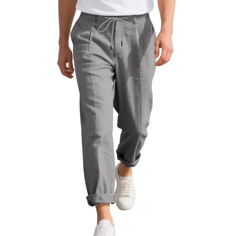 Men's light khaki linen casual trousers with a drawstring waist and straight-leg fit on a hanger.