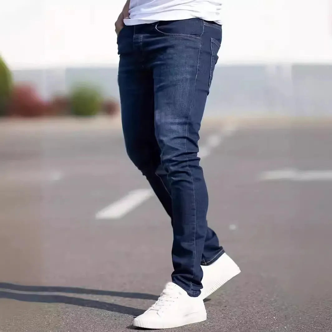 Men's dark blue slim fit casual jeans with a skinny leg and zip fly closure