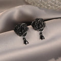Women's rose gold plated flower ear studs with black zircon stones
