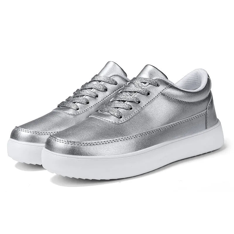 Women's white leather casual flat lace-up shoes on a neutral background.