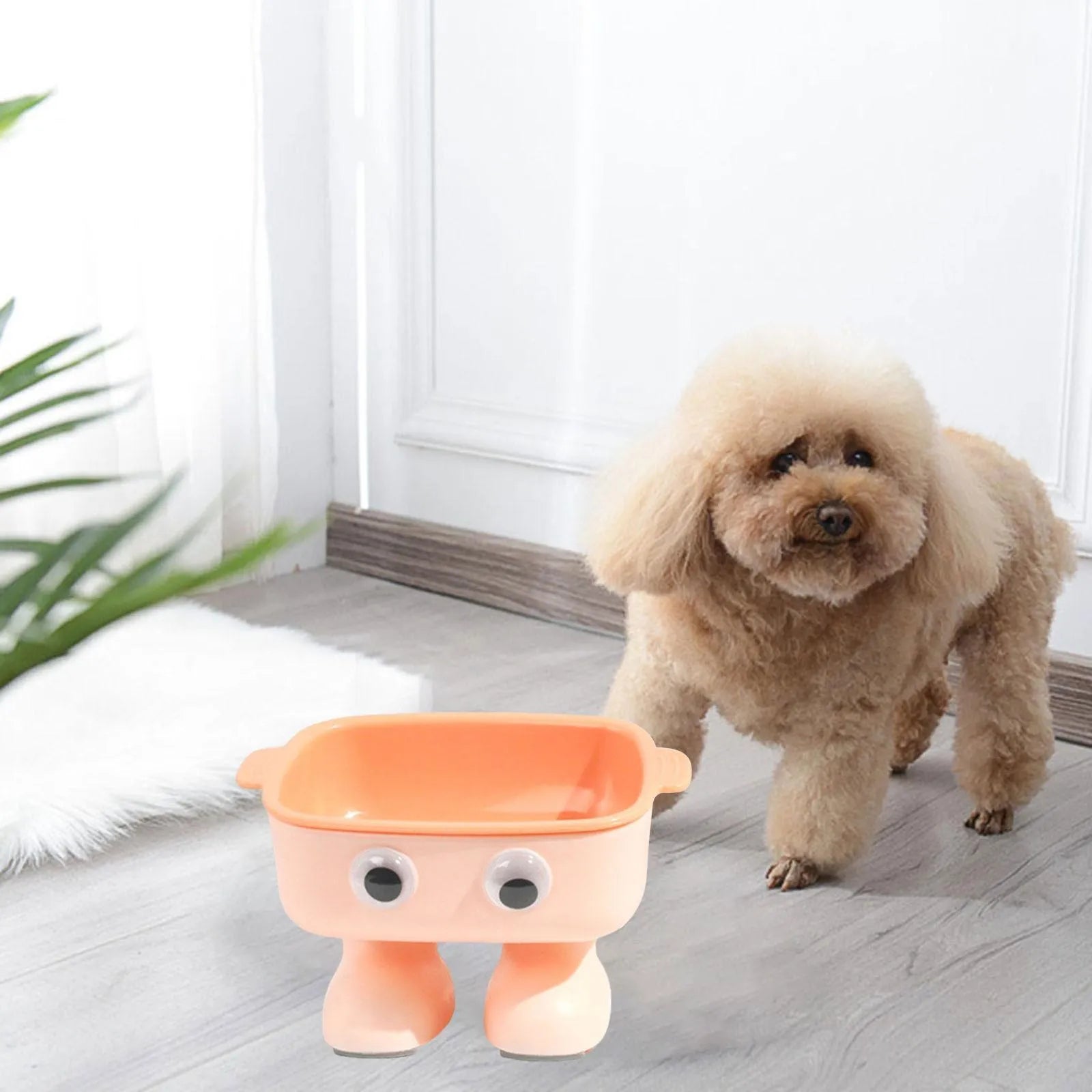 Green robot-shaped elevated cat bowl with tilted food dish and non-slip base.