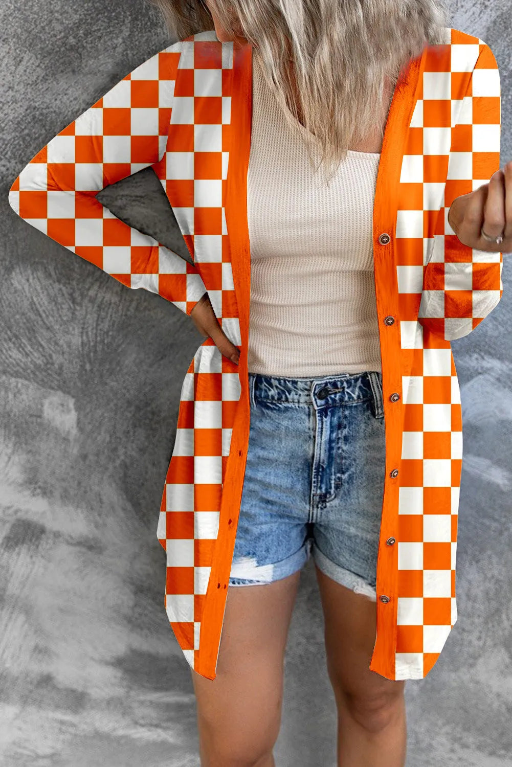 Women's long grey plaid knitted coat cardigan with contrasting colour blocks, loose fit, and regular sleeves.
