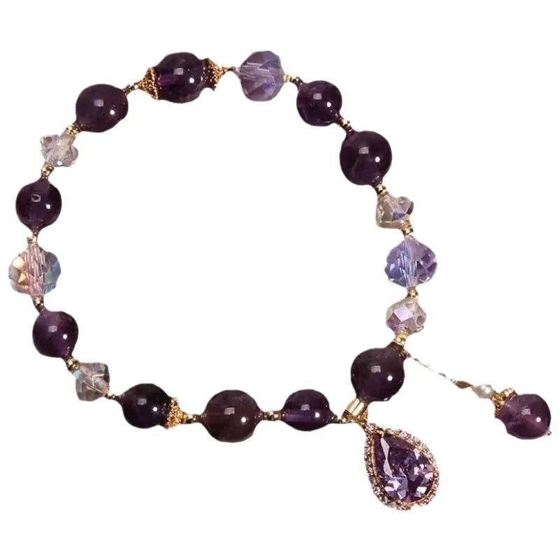 Close-up of a women's purple amethyst crystal bracelet with detailed micro inlay stone setting.