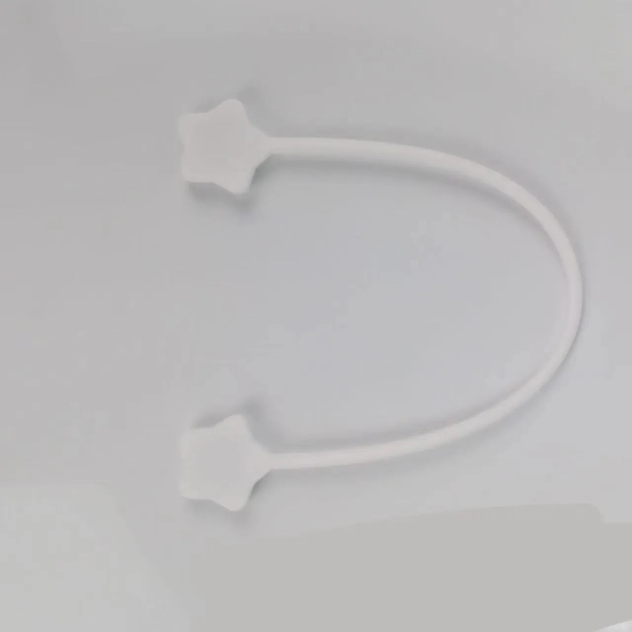 Star magnet silicone wire winder clip in various colours showing wire organisation function