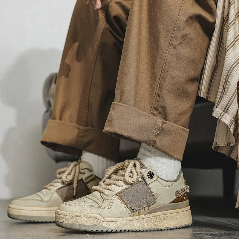Beige vintage skateboard shoes with patch detailing, low-top design, and round toe