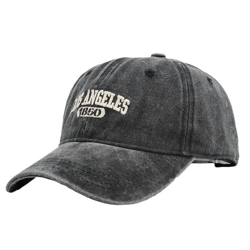 Adult personalised embroidered peaked cap in beige with adjustable strap and distressed lettering.