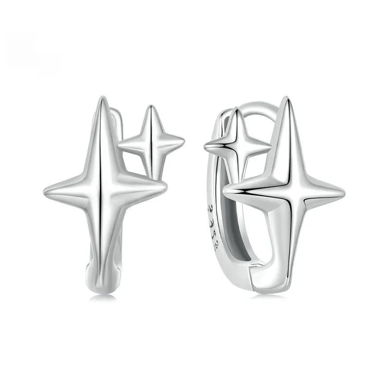 Minimalist oxidised sterling silver ear clips with geometric star designs