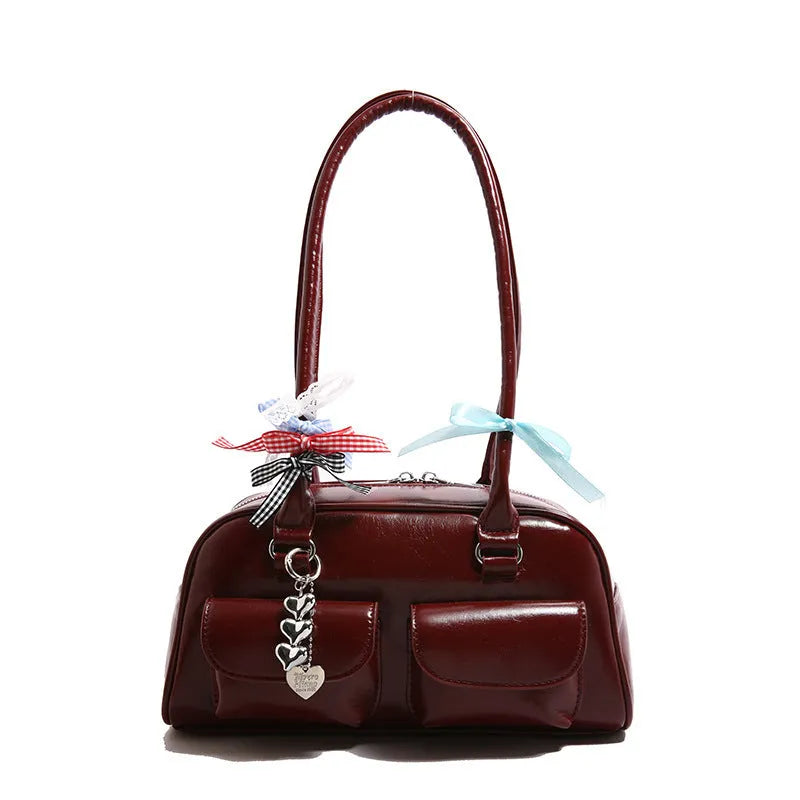 Retro one-shoulder pillow handbag in PU leather, shown in black with a flap closure and double straps.