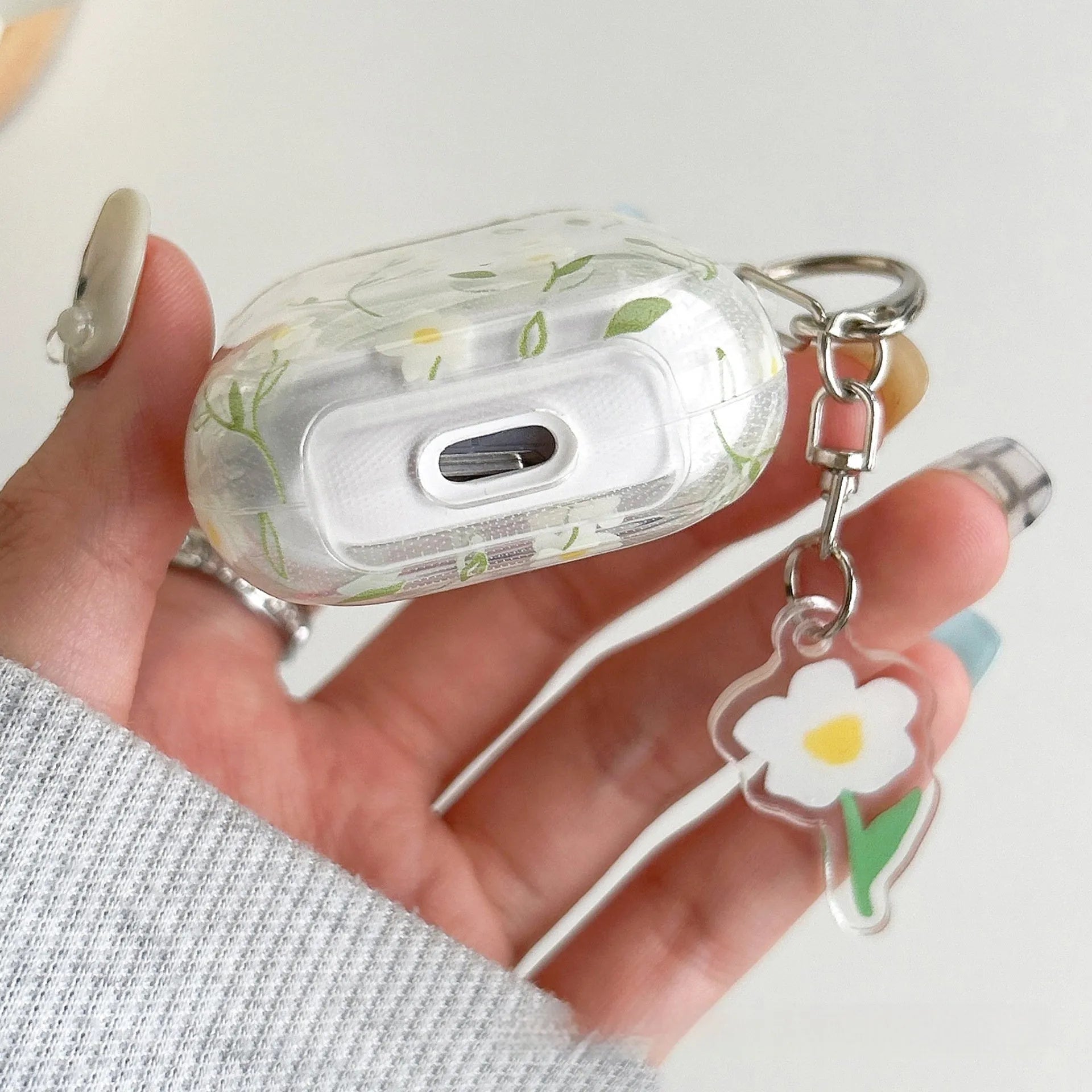 Clear soft TPU protective case for Apple AirPods with white floral oil painting decoration.