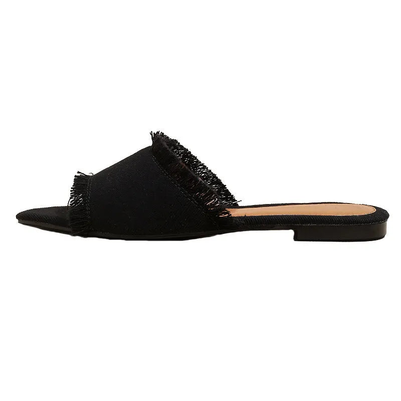 Women's denim flat slippers with a tassel, leather lining, and a PVC sole in various colours.