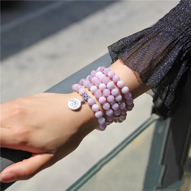 Vintage natural stone bracelet for women with a geometric lotus pendant on a model's wrist.