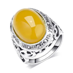 Geometric antique silver ring with fluorescent beeswax amber centre in retro style
