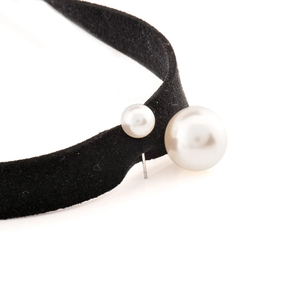 Hand-woven yarn necklace in black with simple college style on a white surface