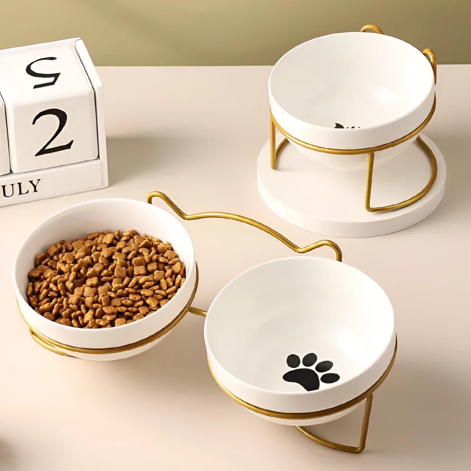 White ceramic pet bowl with decorative pattern in iron frame with cat ear accents