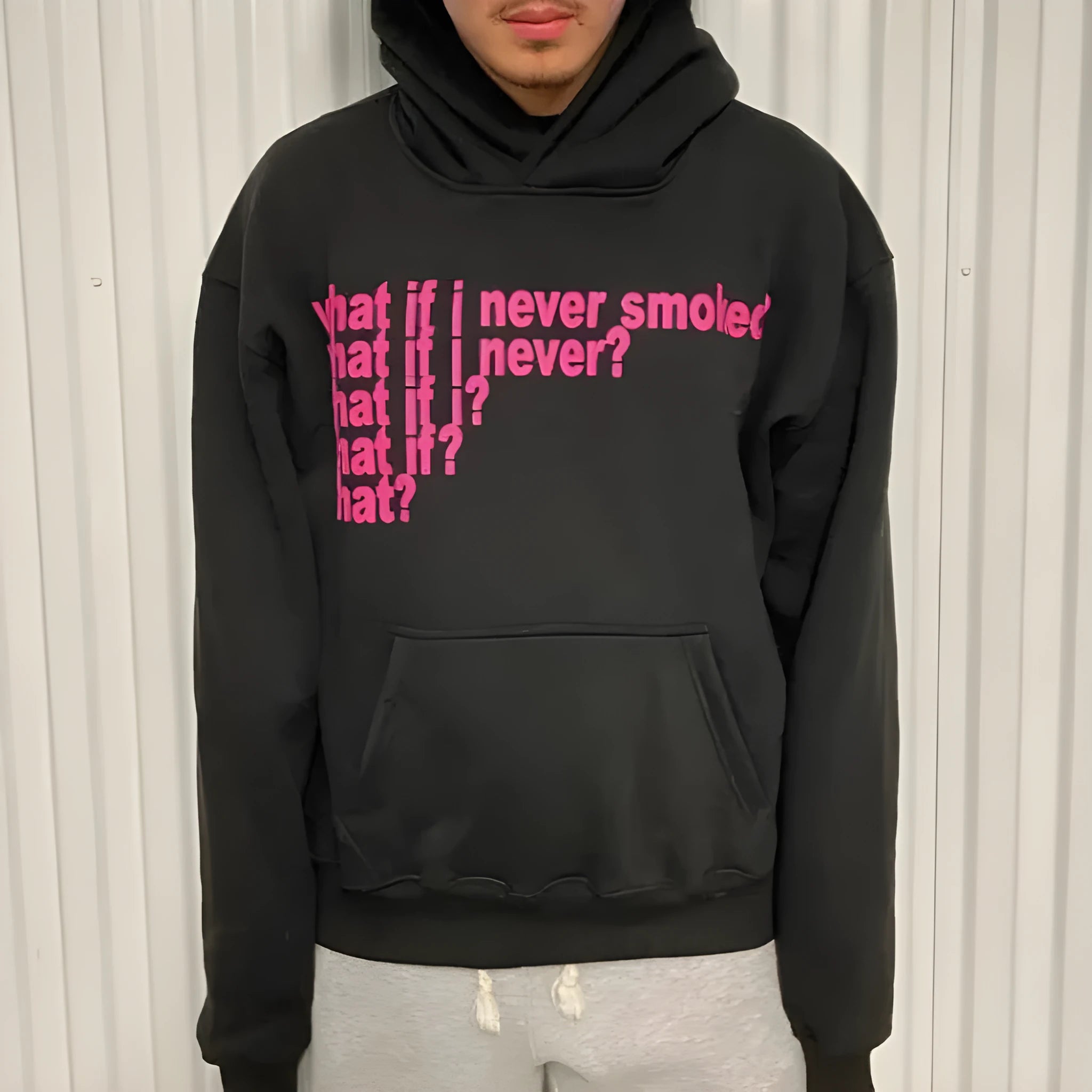 Black hooded sweater with white letter print design on front, showing pullover style with regular sleeves