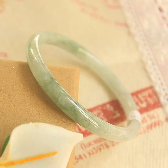 Green waxy jade geometric bracelet with Chinese-style design showing handmade construction