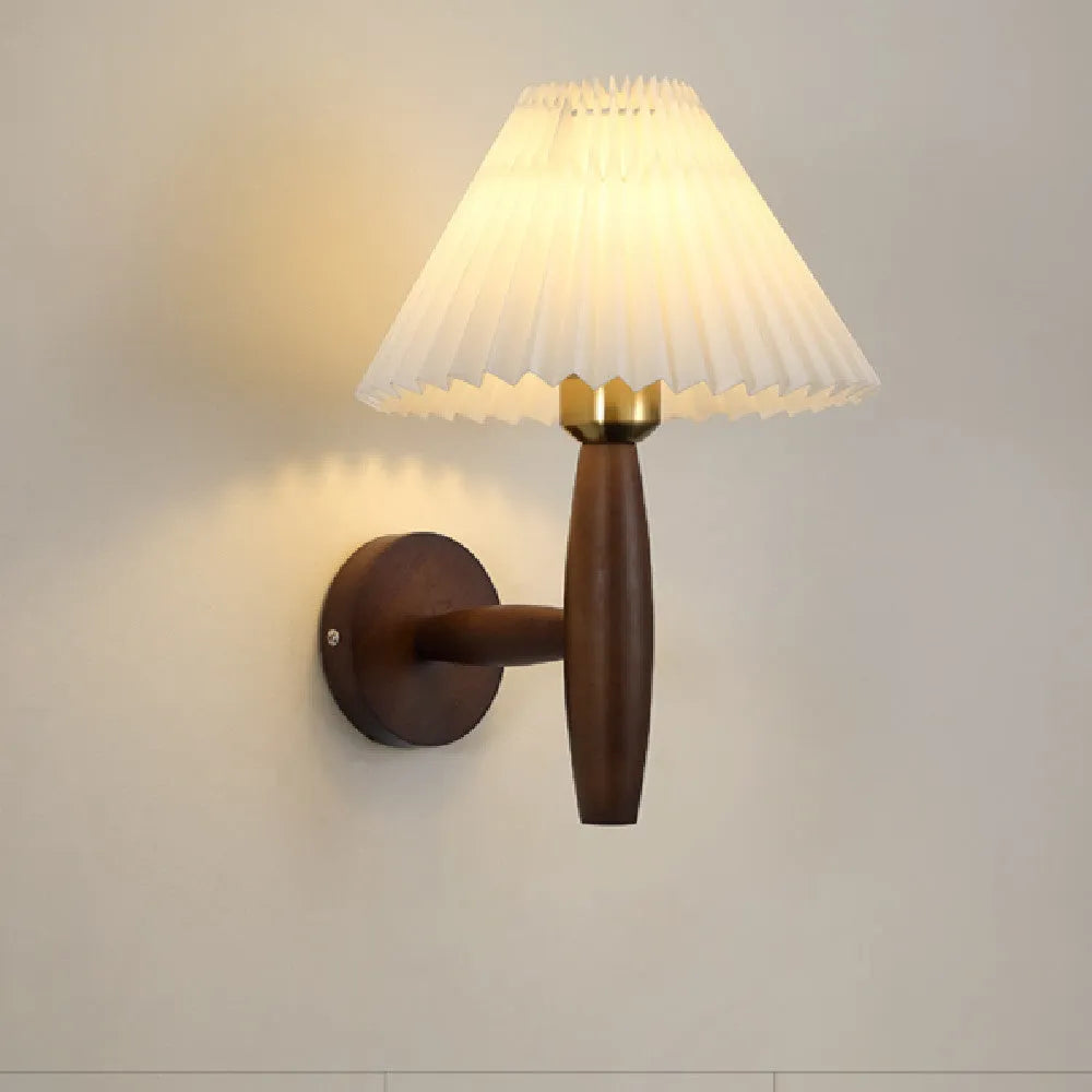 American retro style adjustable wall lamp in walnut wood with a fabric shade, mounted beside a bed.