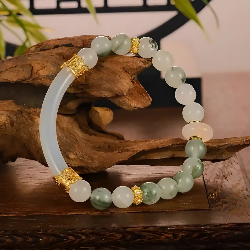 Emerald green jade bracelet with floating flower girl design in a half bracelet style.