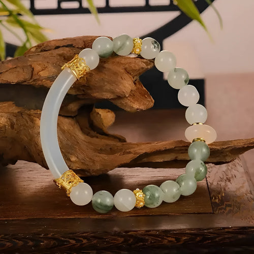Emerald green jade bracelet with floating flower girl design in a half bracelet style.